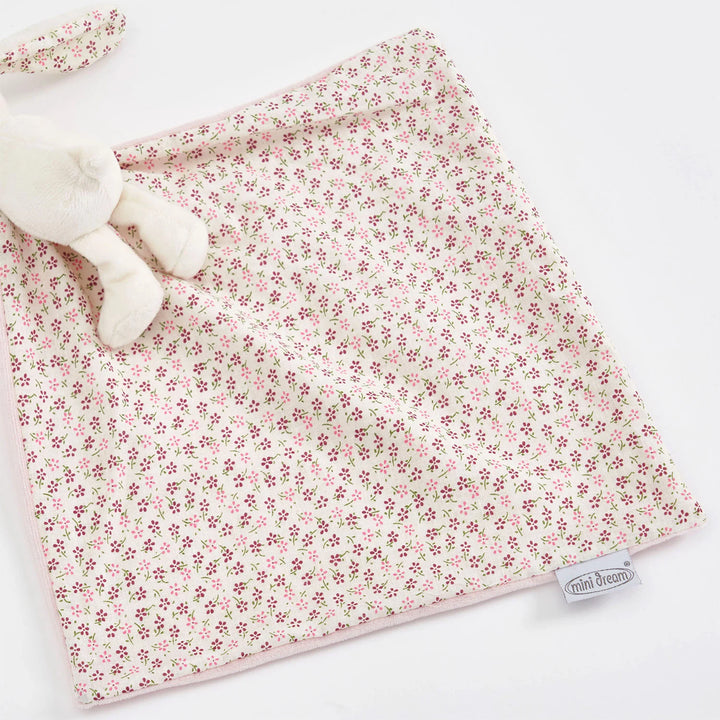 The reversible floral print baby comforter comes with a plush bunny.