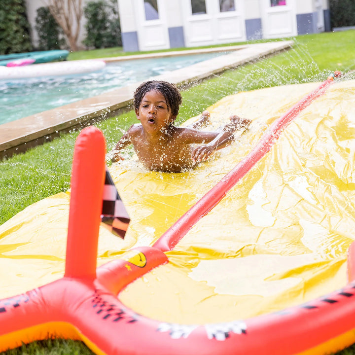 Swim Essential water slide connected to a garden hose, showing a steady stream of water ensuring smooth sliding fun.