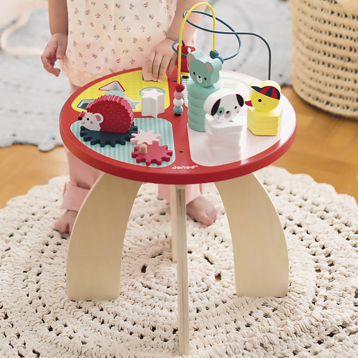 Janod multi activity play table for motor skill development, suitable for children aged 1 year+.