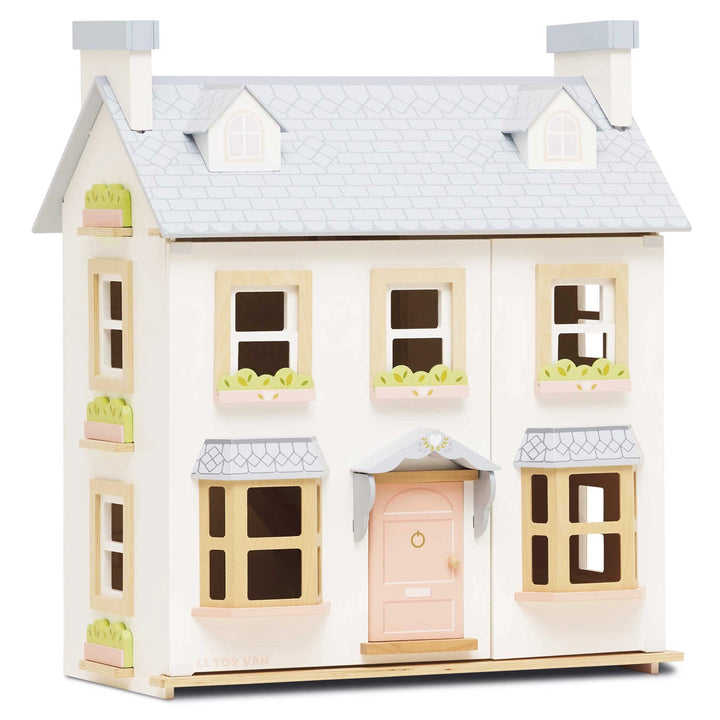 A beautifully crafted wooden dolls house with three floors.