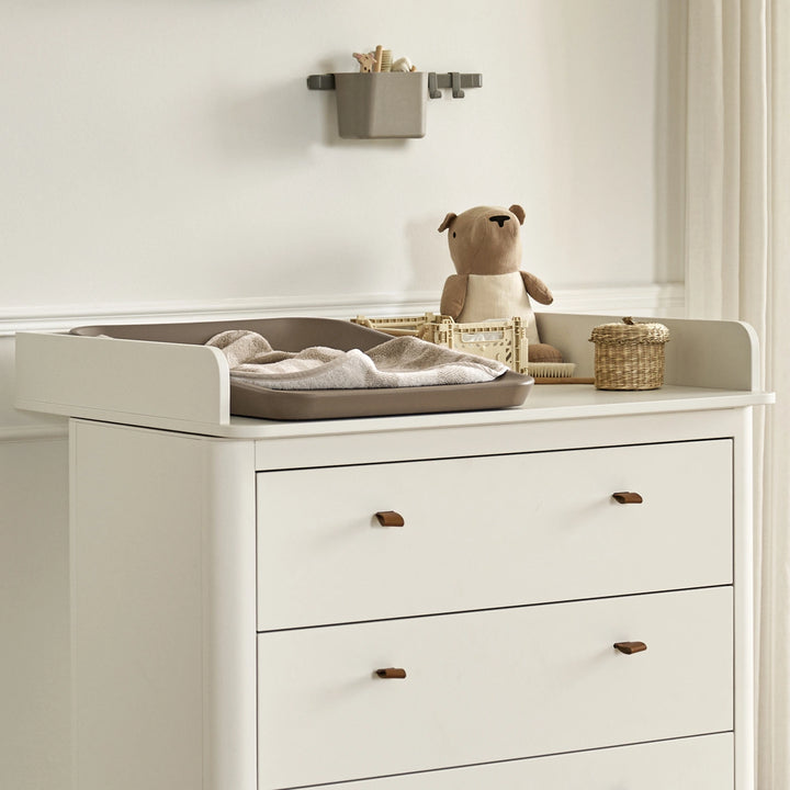 Baby changing table with chest of drawers in white.