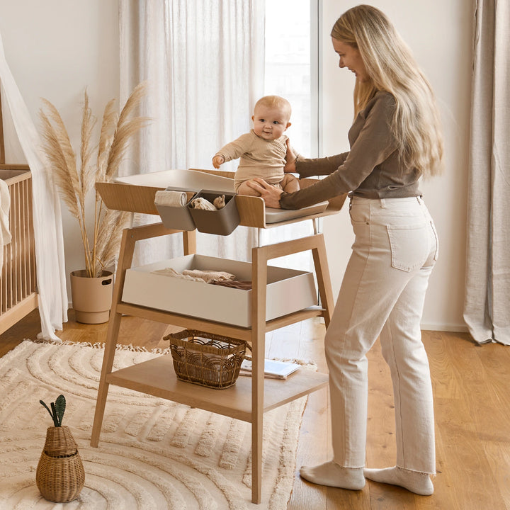 Leander hanging table with foam mat and high edges for safety.