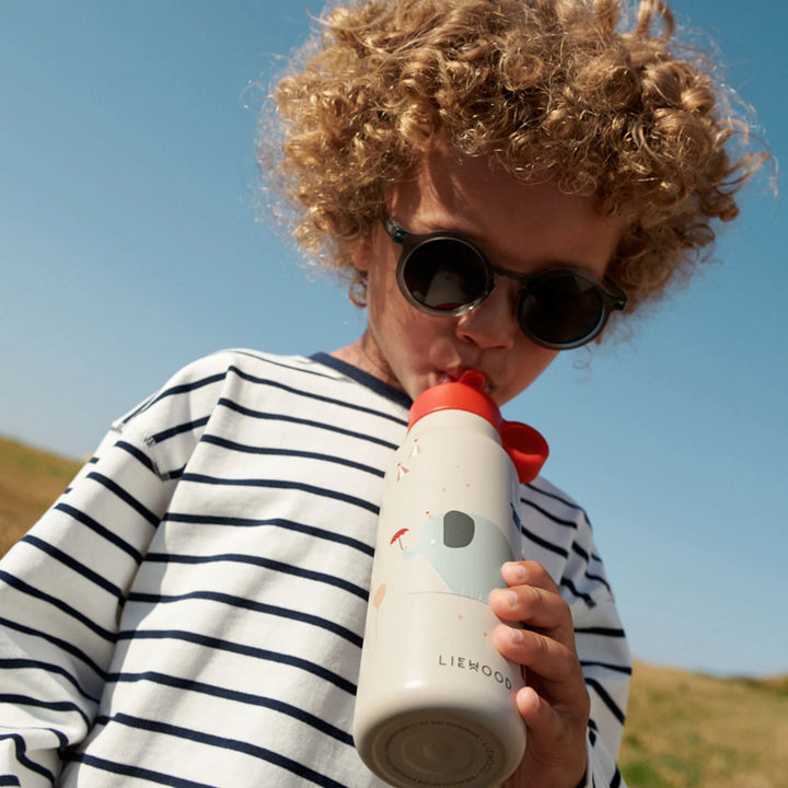 Durable and shatterproof Liewood water bottle in playful signature print with flip-top lid.