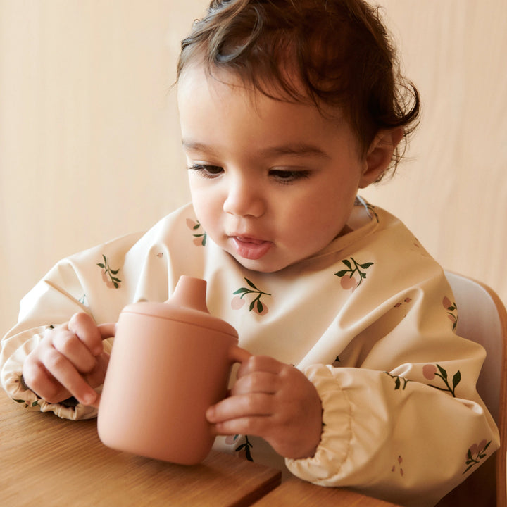 Liewood long sleeve toddler bib in Peach/Sea Shell Mix