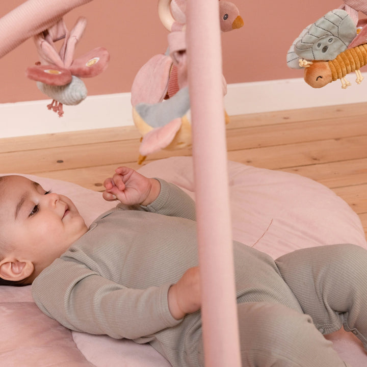 Activity playmat with corduroy arches and bird toys.