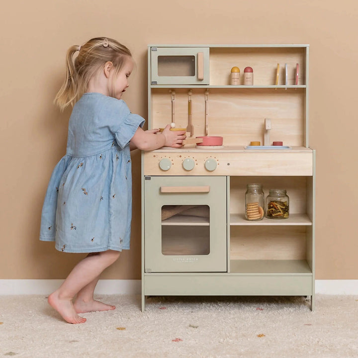 Child playing with the mint-colored Little Dutch Kitchen