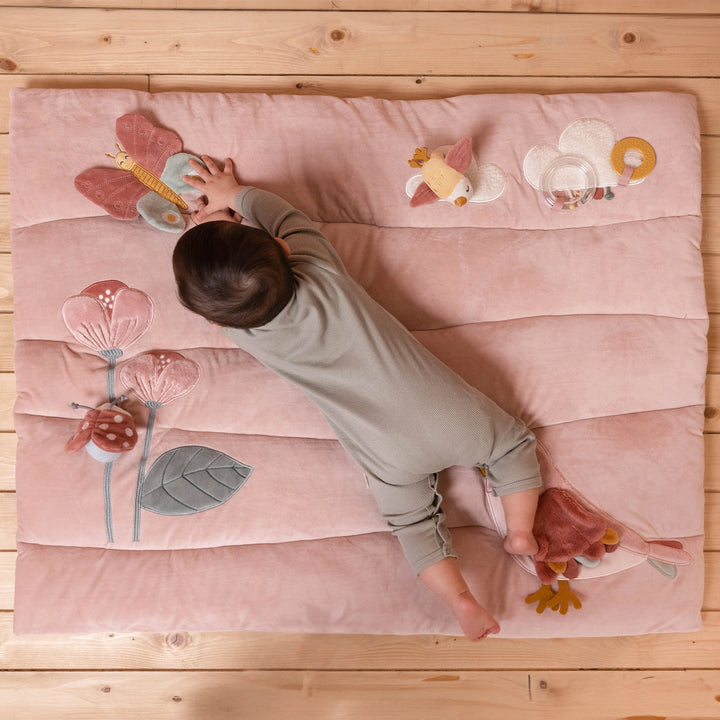 Colourful activity playmat with multiple textures for babies.