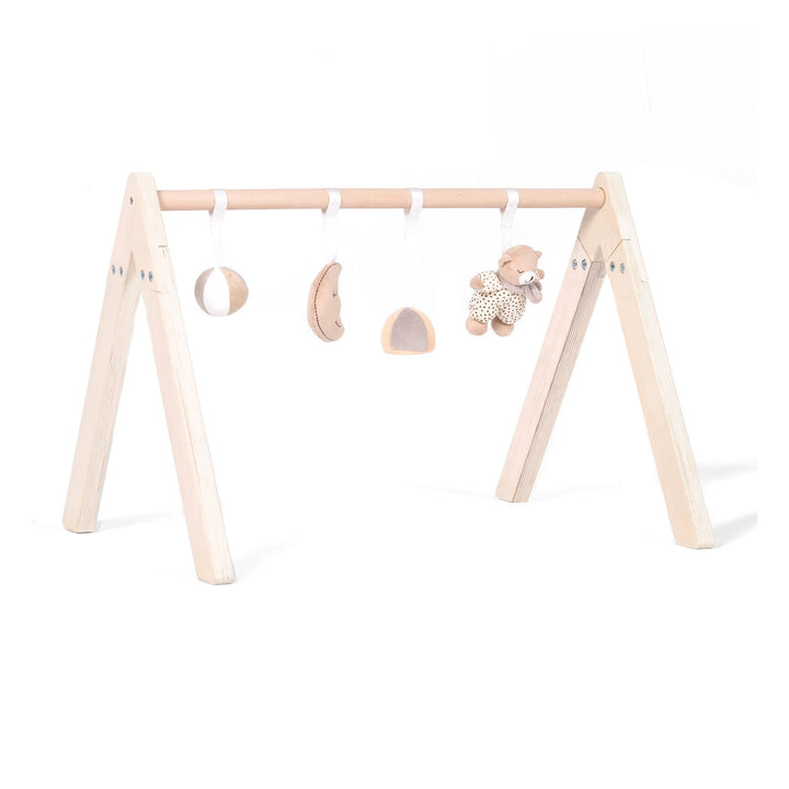 This is a wooden baby gym with a natural wood frame and four hanging toys: a smiling moon, a soft bear, and two spheres.