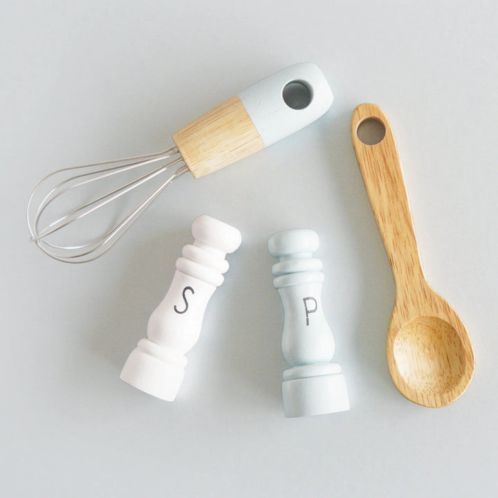 Kitchen Utensils: Includes a whisk, spoon, salt, and pepper shakers.