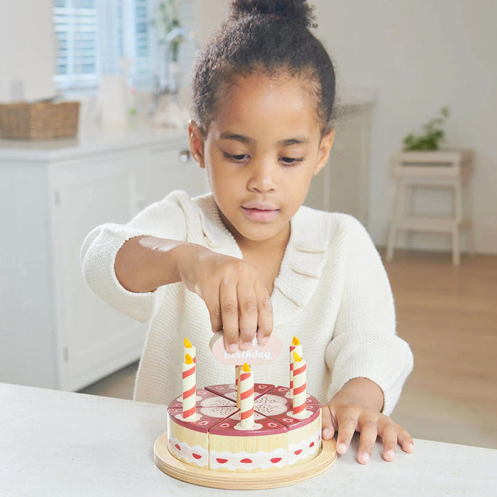 Tender Leaf Toys chocolate cake on wooden plate.