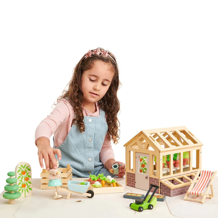 Children playing with Tender Leaf Greenhouse and Garden Set.