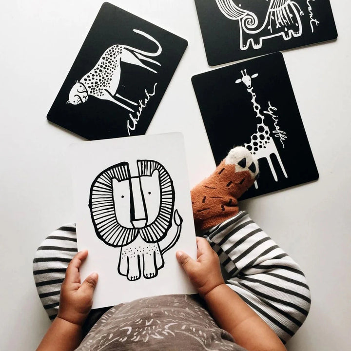 A baby is playing with a jungle animal collection.