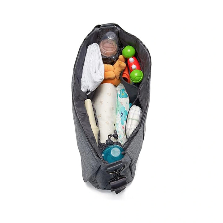 Top-down view of the Baby Changing Bag Messenger - Grey packed with baby essentials like diapers, bottles, and toys, highlighting its organized compartments and spacious interior, shown on a white background.