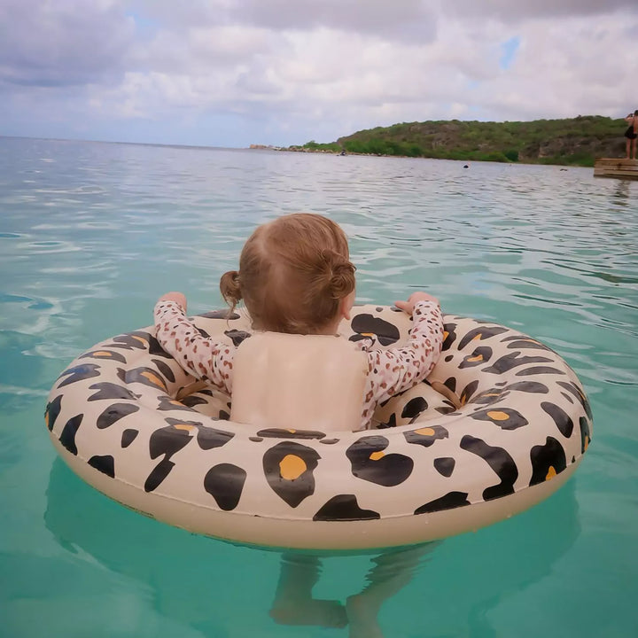 Baby enjoying the swim float in a pool - Capturing the joy and comfort of a baby experiencing their first swim, safely supported by the float.