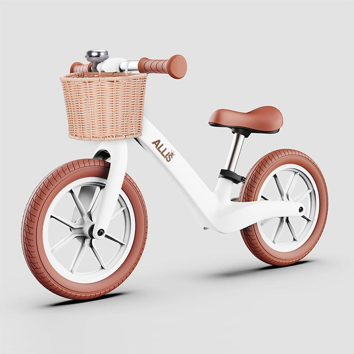 White LUMI bike for 2 year old with stylish brown basket and bell