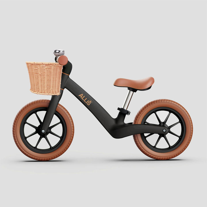 Matte black LUMI balance bike with basket and bell