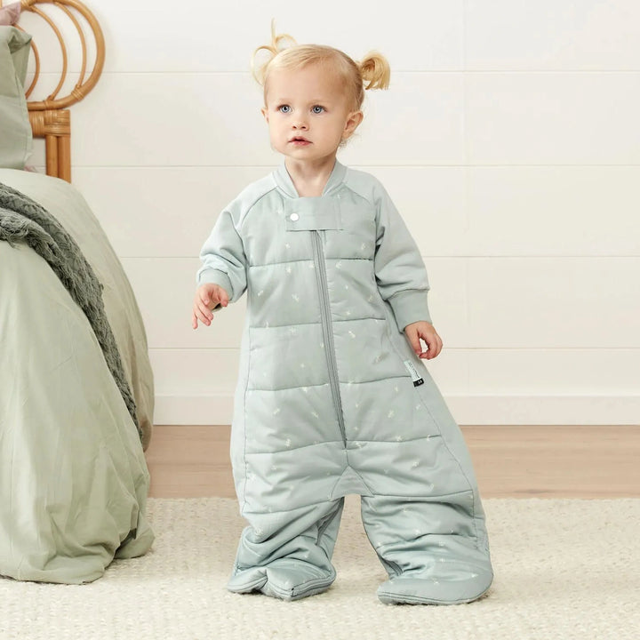 Baby wearing sleep suit bag with leg openings