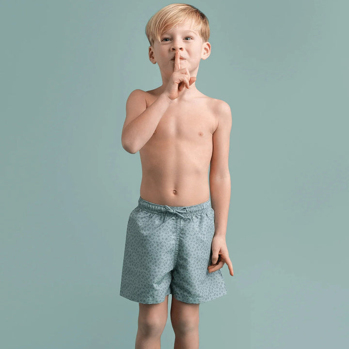 Kid confidently adjusting the drawstring on Swim Essentials Kids' Swim Shorts for a perfect fit.