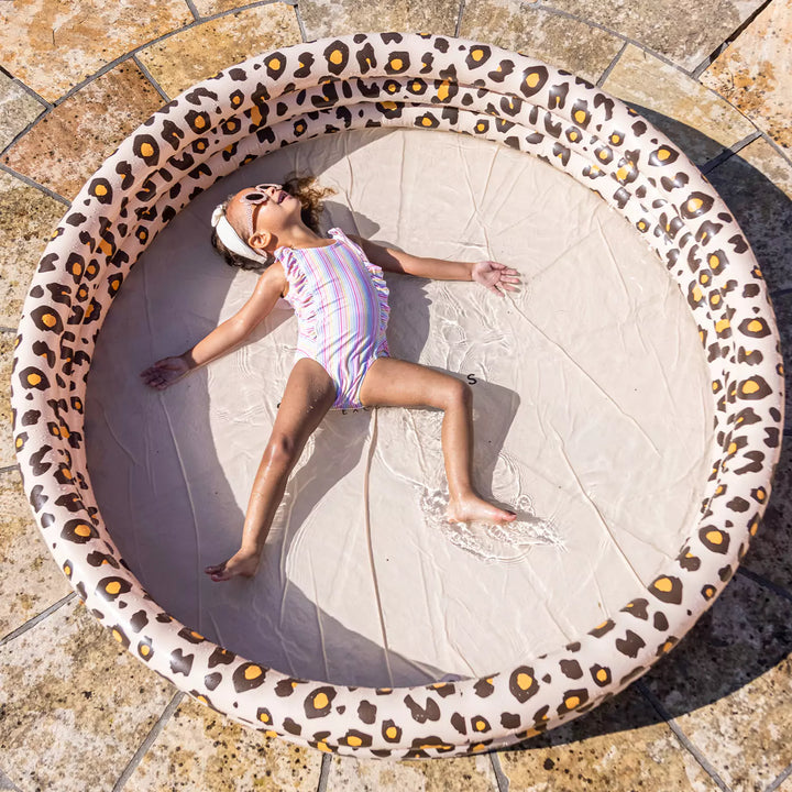 Children having a blast in the large Panther print paddling pool, surrounded by its unique beige design.