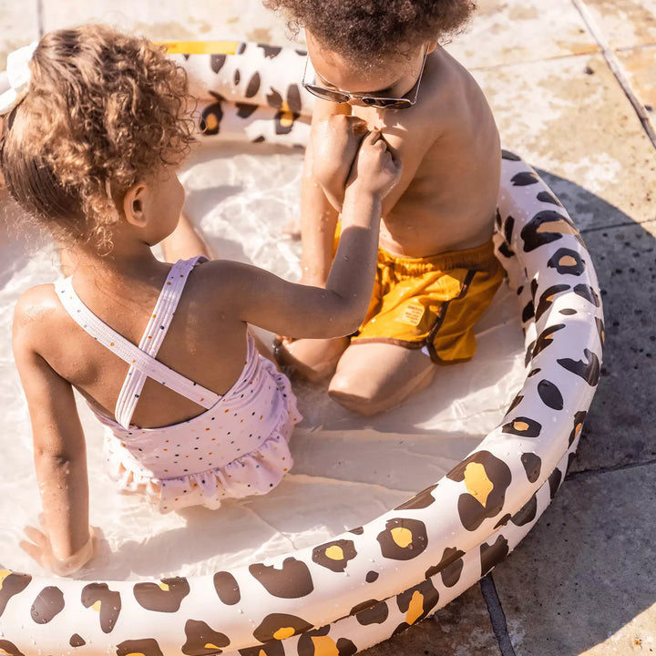 Kids playing and splashing with friends in the spacious Panther print paddling pool on a sunny day.