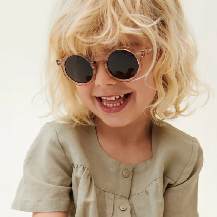 A close-up of a child wearing Darla sunglasses with a matte finish, showcasing the durable polycarbonate frame.