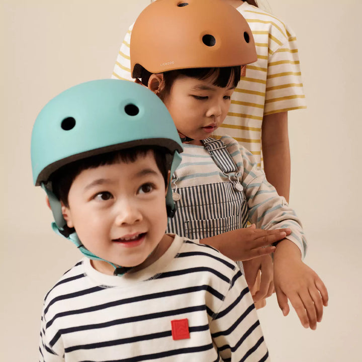 The secure buckle closure and adjustable webbing straps of the helmet ensure a snug and comfortable fit for young cyclists.