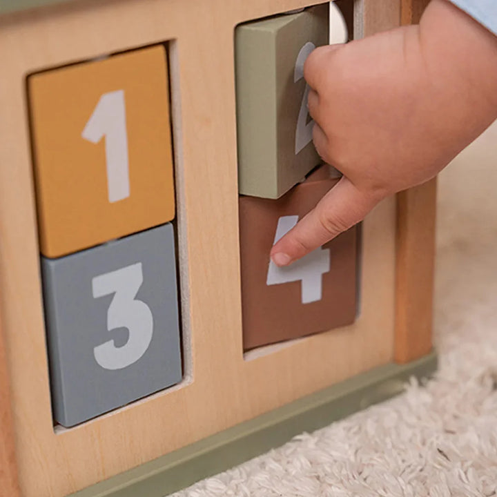 Little fingers sort colourful shapes into corresponding holes, fostering shape and colour recognition skills.