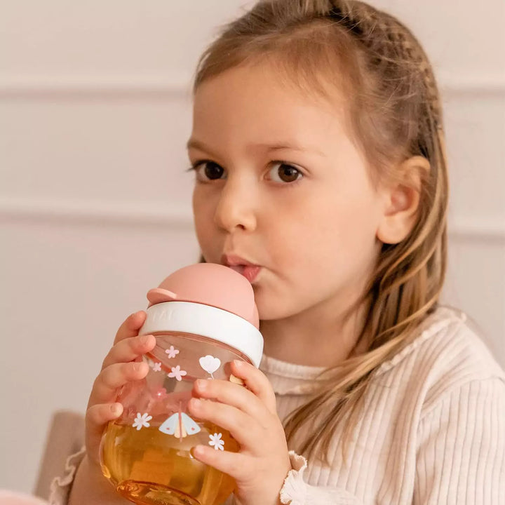 The child is drinking from the Mepal Mio Cup, which promotes independence.