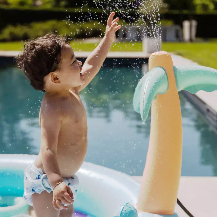 Happy children paddling and playing in the Rainbow Paddling Pool on a sunny day.