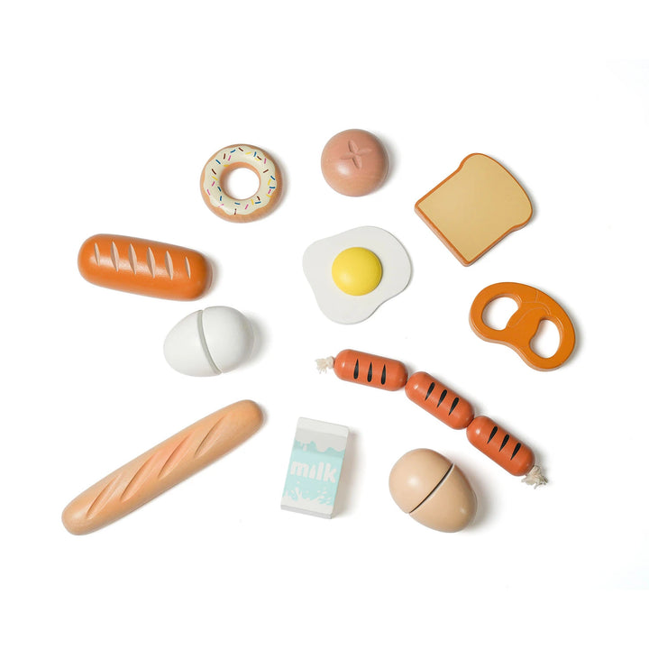 The display showcases a variety of wooden toy food items for a fictitious breakfast, such as a donut, bread, milk, eggs, sausage, and a pretzel.